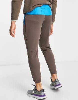 Nike Running Trail Tour Du Mont Blanc joggers in brown ASOS