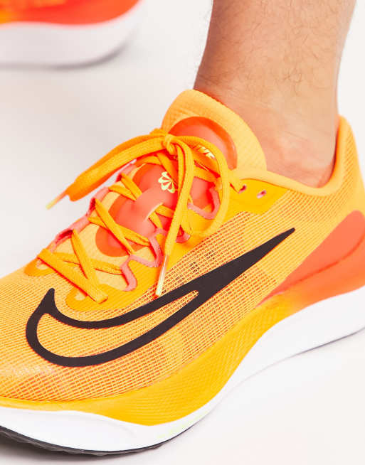 Nike orange and store yellow running shoes