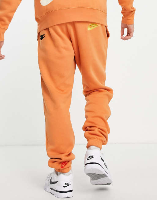 Nike - Rally Burnt - Pantalon de jogging à logo - Orange, ASOS