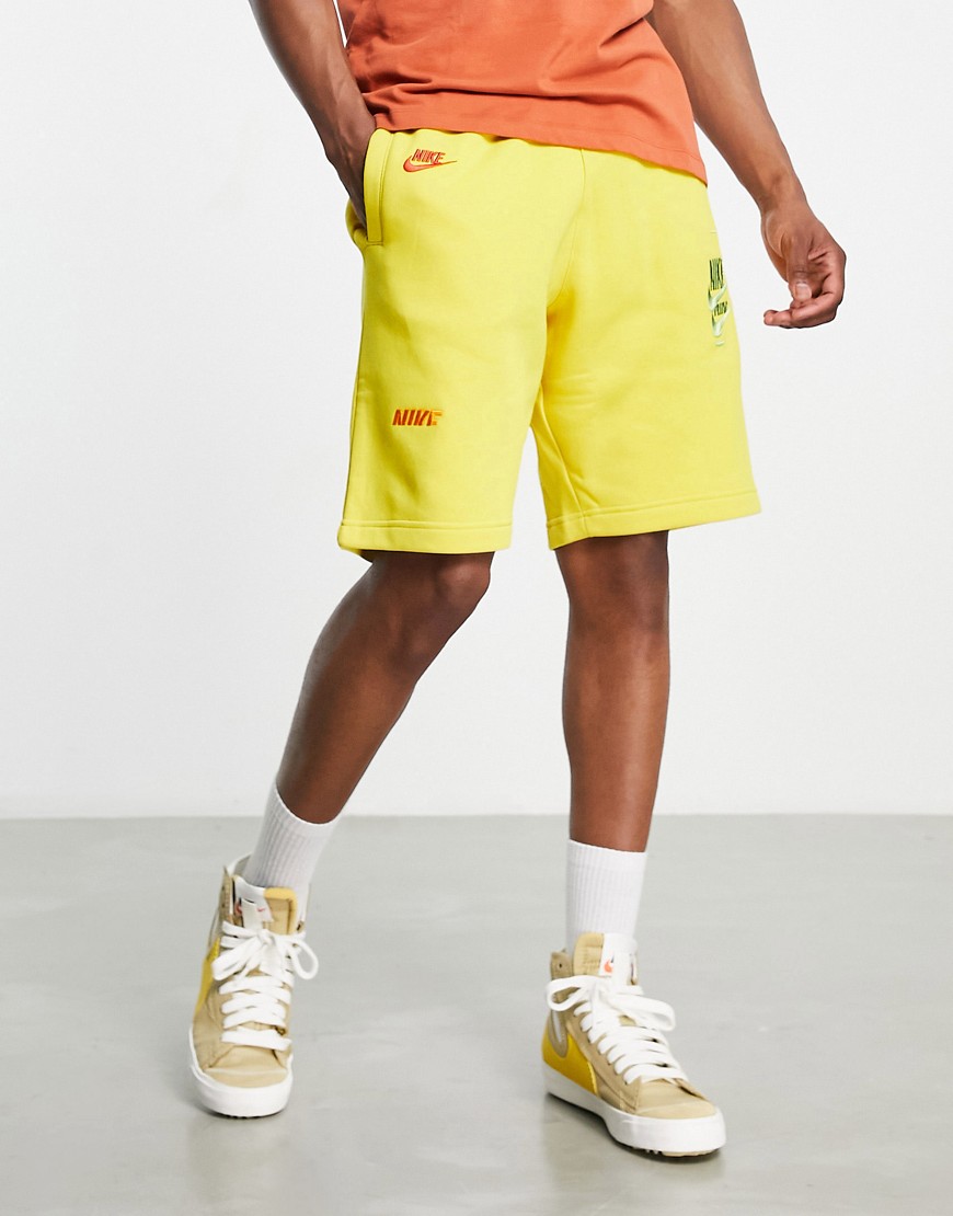 Nike Sport Essentials multi-futura logo fleece shorts in yellow