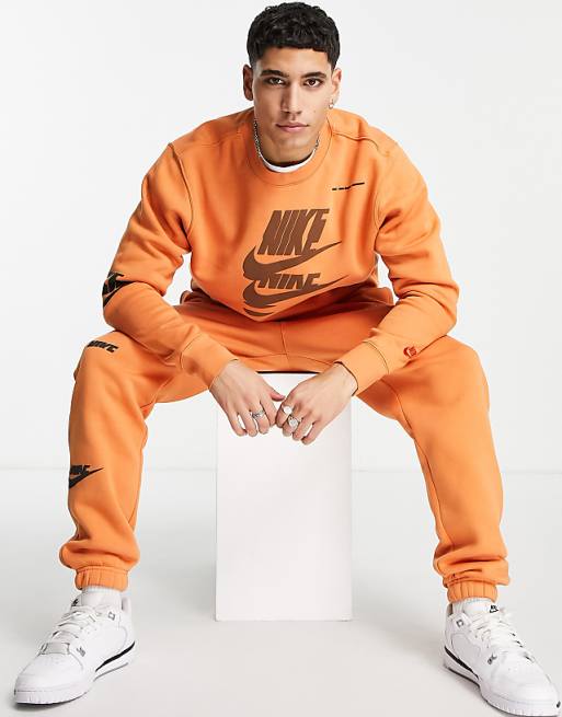 Nike Sport Essentials Multi Futura logo fleece sweatshirt in orange Nike Sport Essentials Multi Futura logo fleece sweatshirt in orange