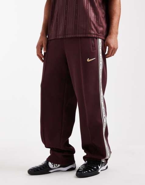 Nike striped tapered joggers in burgundy