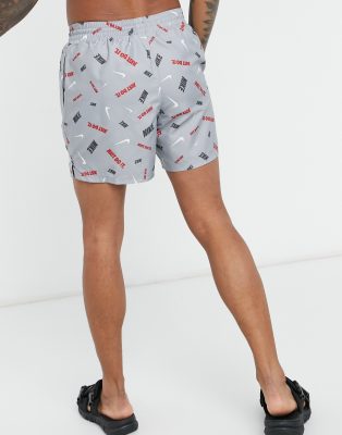 nike swimming 5inch volley shorts with all over swoosh print in black