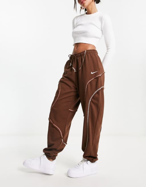 Nike swirl print loose fit fleece cuffed joggers in brown ASOS