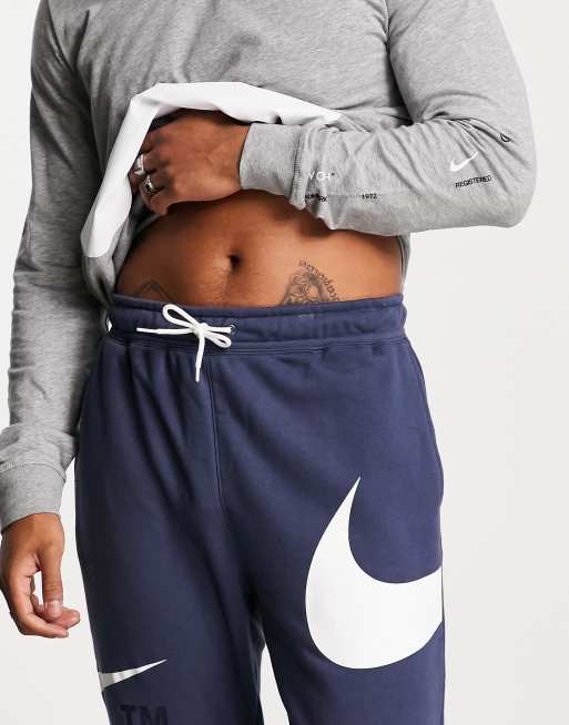 Nike Swoosh Bla joggingbukser med stram buksekant ASOS