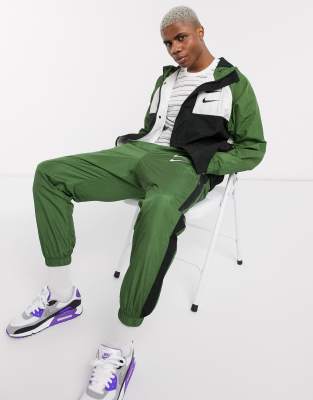 nike swoosh cuffed woven sweatpants in khaki