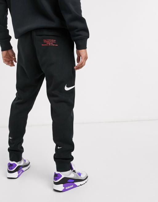 Nike Swoosh cuffed joggers in black ASOS