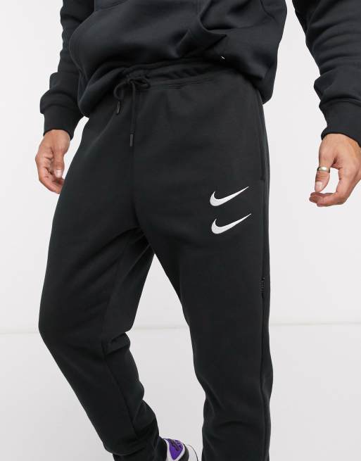 Nike Swoosh cuffed joggers in black ASOS