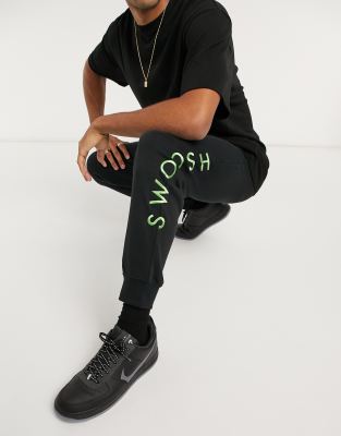nike swoosh logo cuffed joggers in black