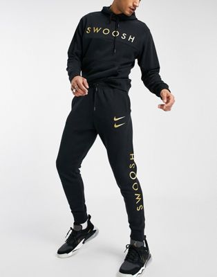 Nike Swoosh tracksuit set in black and 
