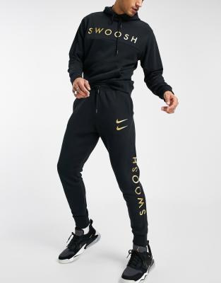 nike black gold tracksuit