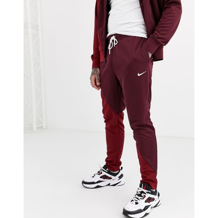 Nike Swoosh cuffed joggers in burgundy red ASOS