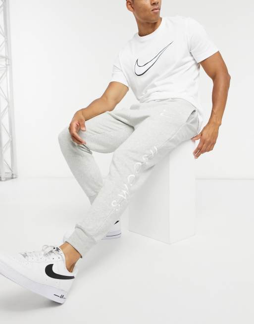 nike repeat pack polyknit logo taping cuffed joggers in white