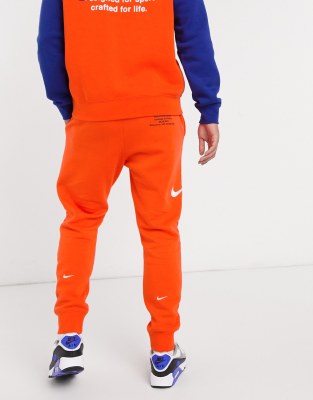 orange nike jogging pants