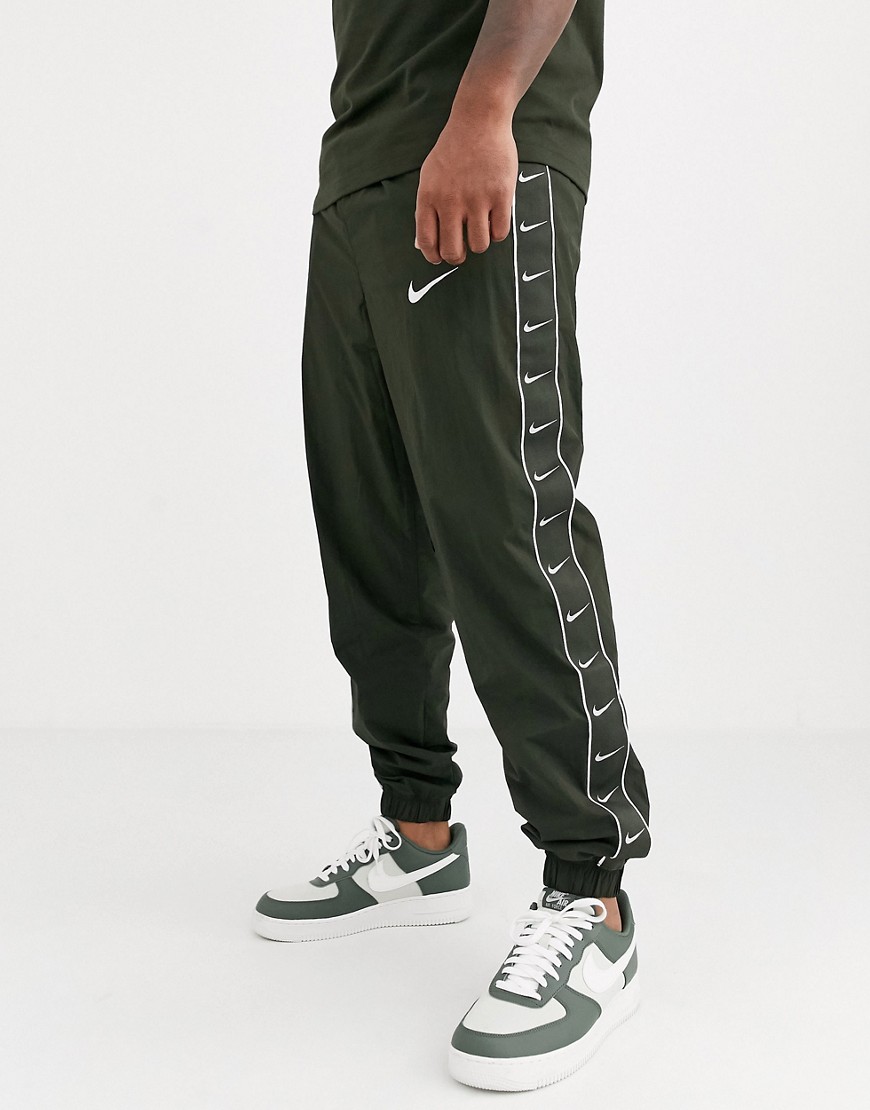 Nike Swoosh cuffed joggers with taping detail in khaki-Green