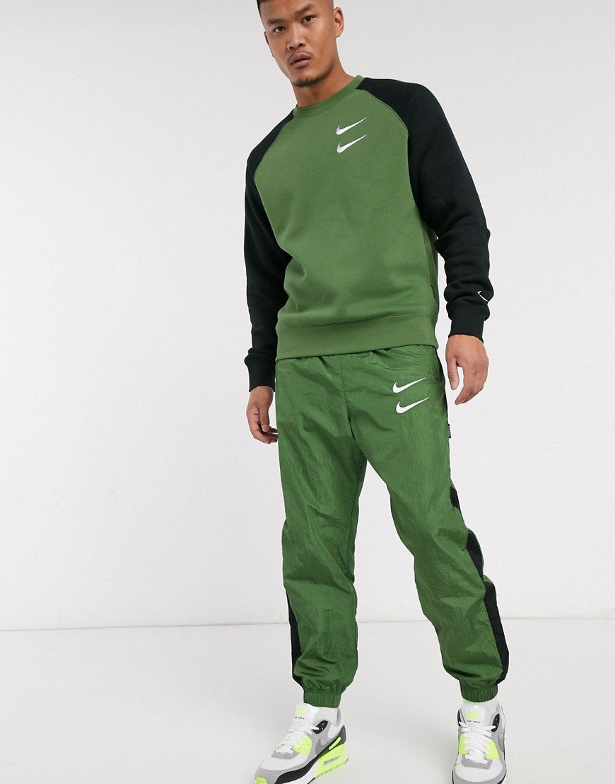 Nike Swoosh cuffed woven joggers in khaki-Green