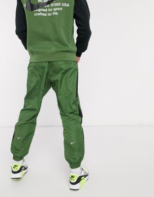 nike swoosh cuffed woven sweatpants in khaki