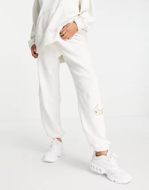 Nike Swoosh fleece joggers in phantom white ASOS