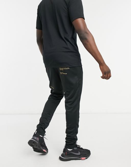 Nike black and gold hot sale sweatpants