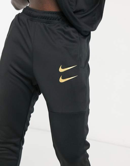 Nike Swoosh joggers in black and gold ASOS