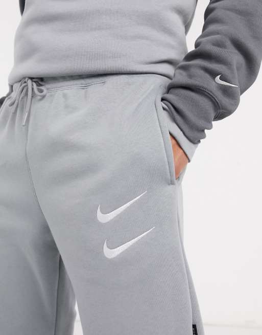 Nike Swoosh logo cuffed joggers in grey ASOS