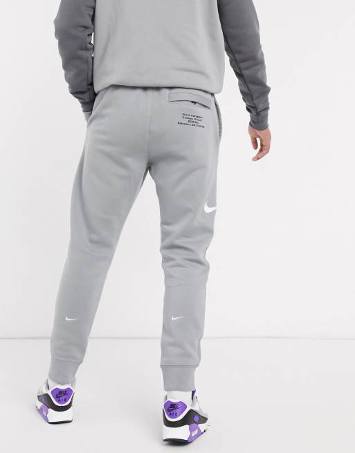 Nike Swoosh logo cuffed joggers in grey ASOS