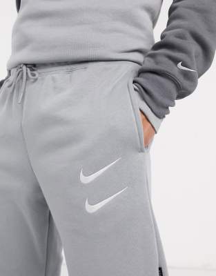 nike swoosh logo cuffed joggers in grey