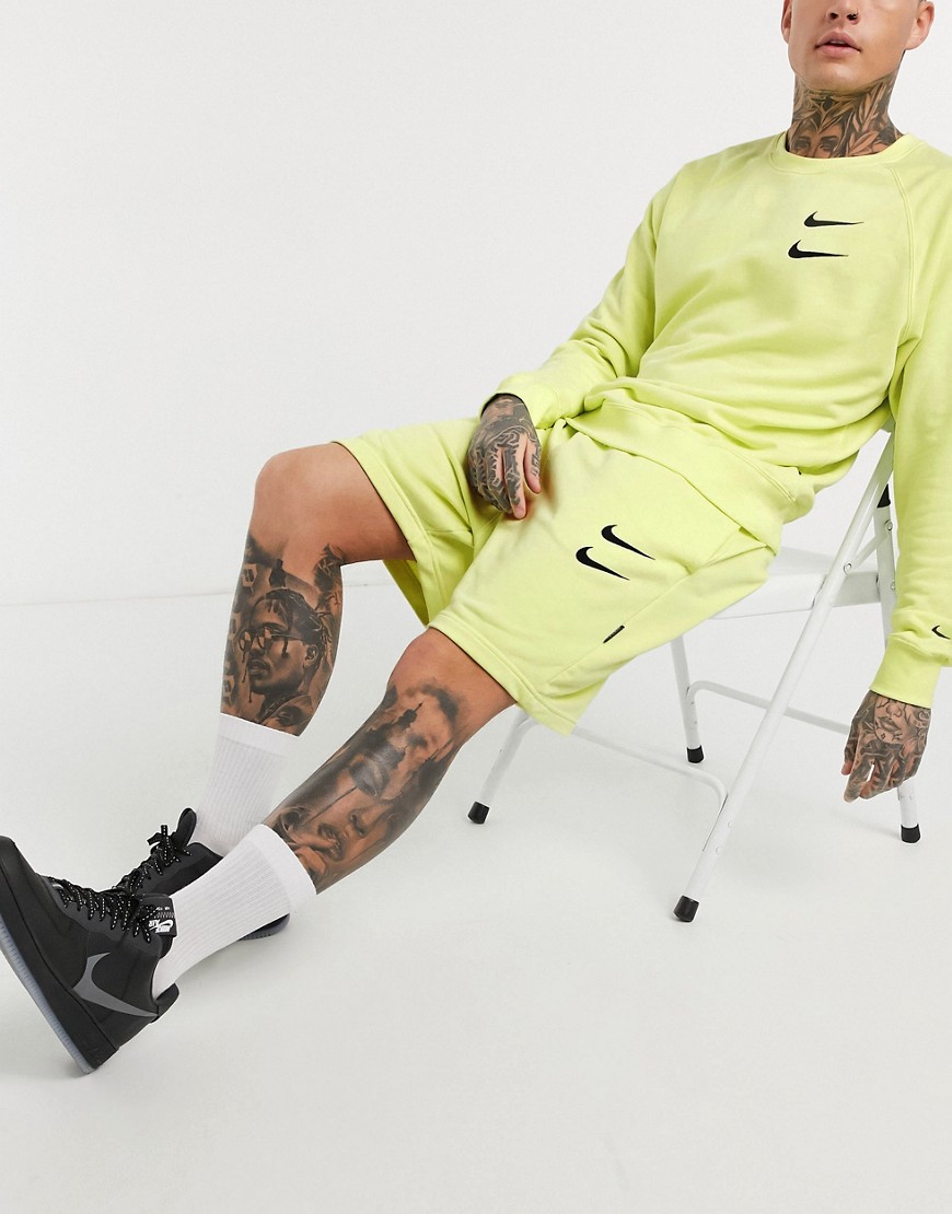 Nike Swoosh logo shorts in neon yellow