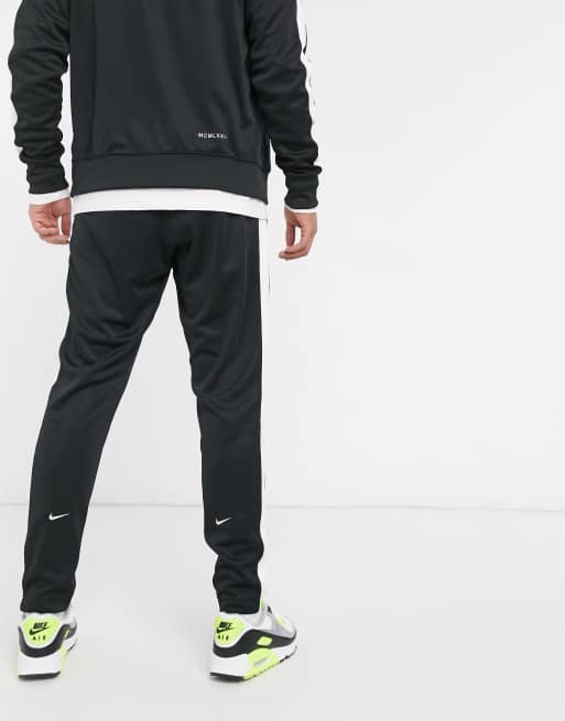 Nike Swoosh polyknit joggers in black ASOS