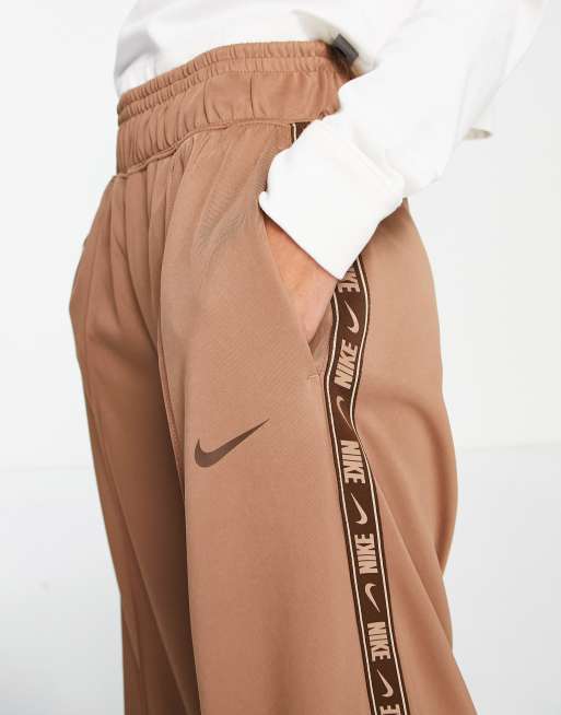 Nike swoosh best sale taped track pants