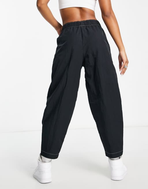 Nike Swoosh woven high-waisted panelled pants in black | ASOS