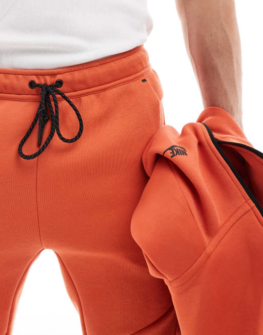 Nike Tech Fleece cuffed sweatpants in orange ASOS