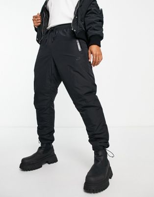 Nike Tech Fleece woven joggers in black with toggle detail