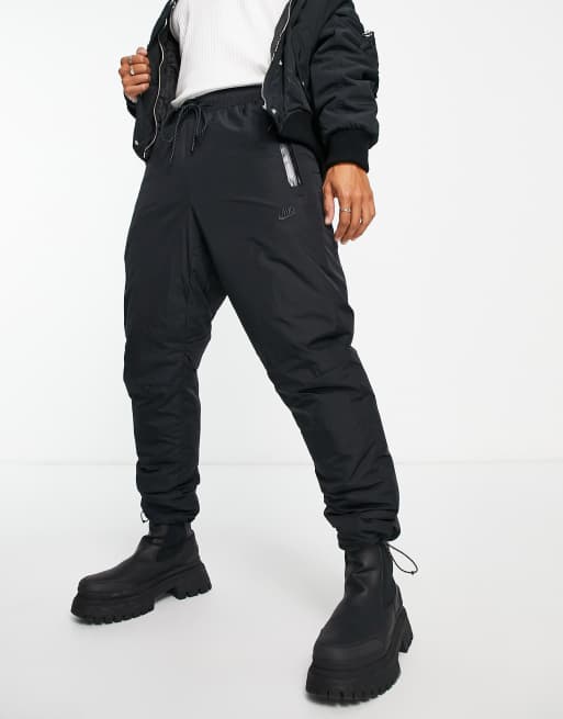 Nike Tech Fleece woven joggers in black with toggle detail | ASOS