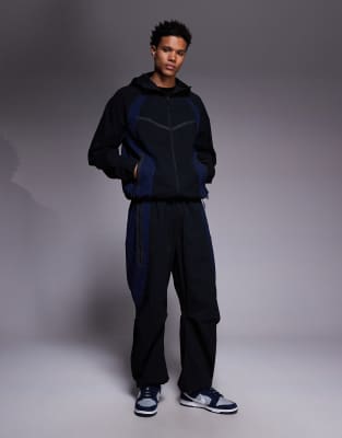 Nike - Tech - Pantalon de jogging tissé - Noir et bleu