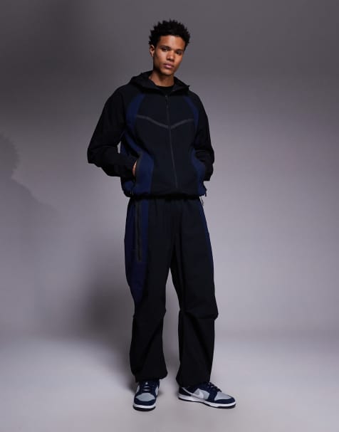 Nike Tech Woven joggers in black and blue