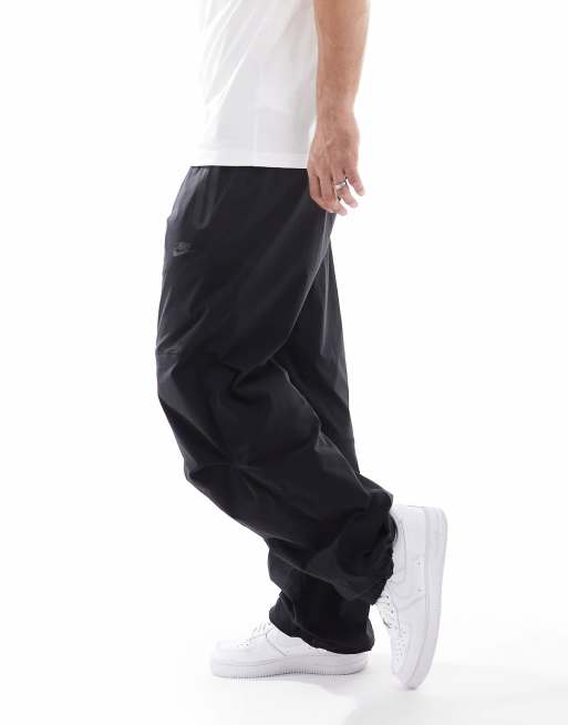 Nike Tech Woven loose fit trousers in black ASOS