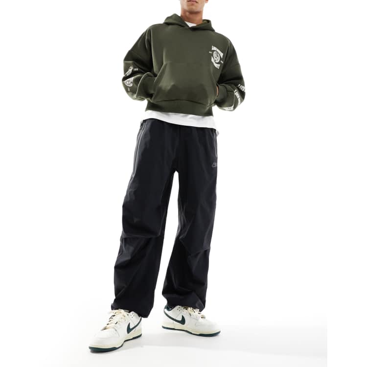 Nike Tech Woven oversized pants in black | ASOS
