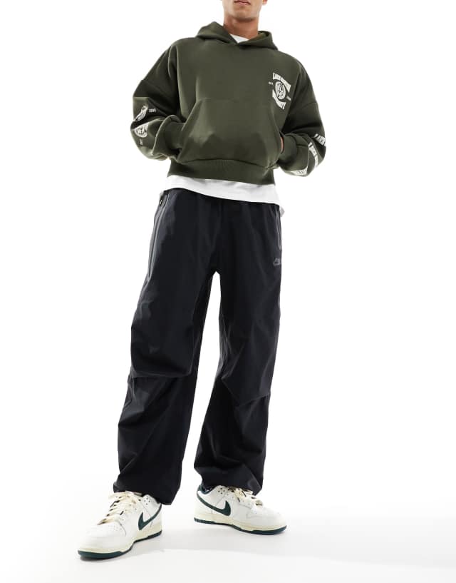 Nike Tech Woven oversized pants in black | ASOS