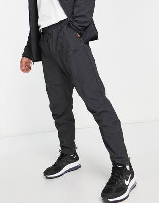 Nike textured tech fleece woven trousers in black