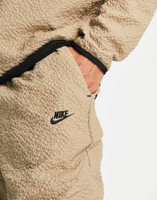 Nike textured tech fleece woven trousers in khaki beige ASOS