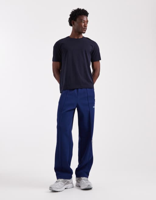 Nike - Toelopende joggingbroek met strepen in marineblauw, 3 van 5