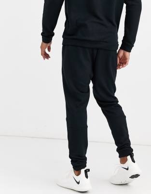 nike training tapered fleece pants in black