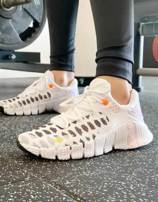 nike training metcon sneakers in white and orange