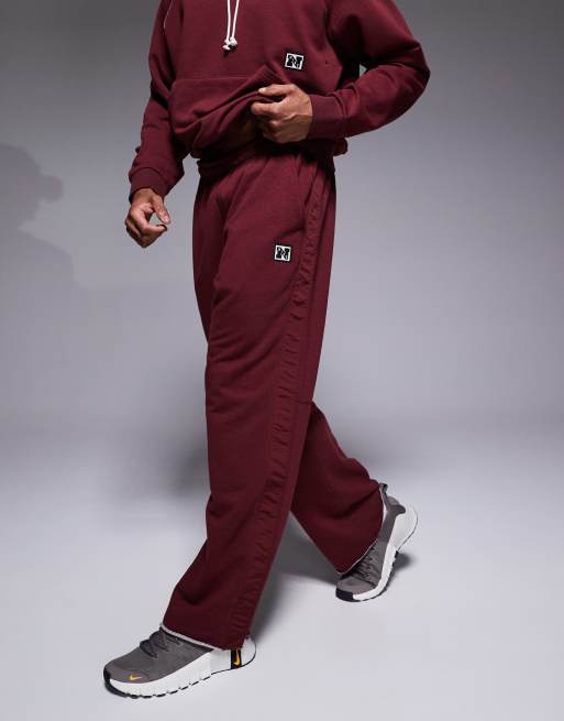 Nike Training Heritage Dri-FIT joggers in red