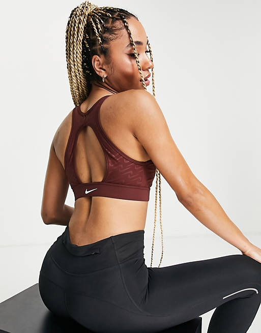 Women Nike Training Icon Clash Dri-FIT Swoosh medium support sports bra in bronze 