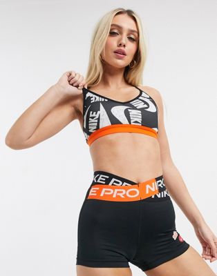 Nike Training - Icon Clash - Reggiseno nero e arancione con stampa | ASOS