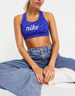Nike Training Icon Clash Swoosh AOP graphic medium support sports bra in blue - ASOS Price Checker