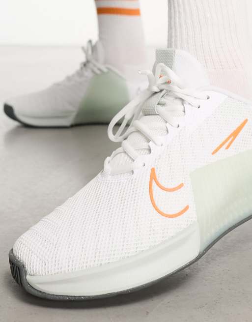 Nike training metcon sneakers hotsell in white and orange