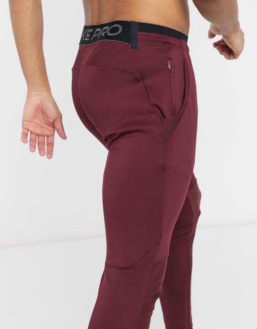 Nike Training NPC joggers in burgundy ASOS